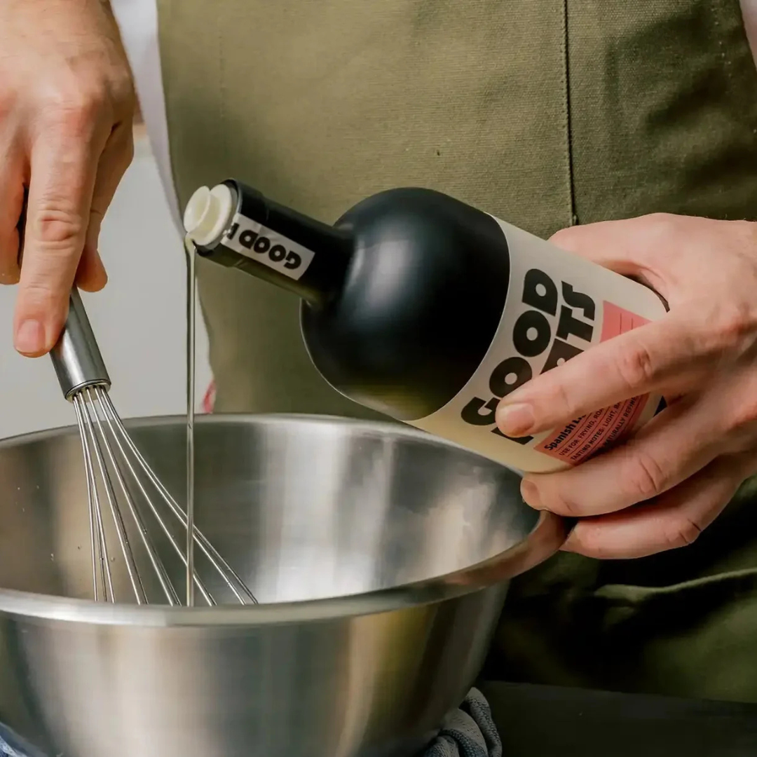 Refined avocado oil being poured into a bowl while whisking ingredients, neutral cooking oil for emulsions and high-heat use (Good Phats)